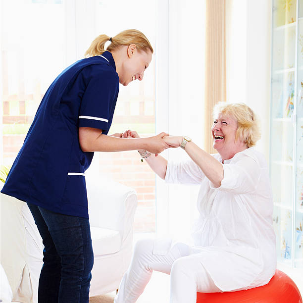 istock young care worker helping senior woman with Exercises 108696209