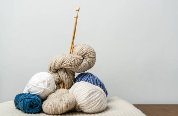 istock close up view of knitting clews with knitting needles on grey backdrop 1086969390