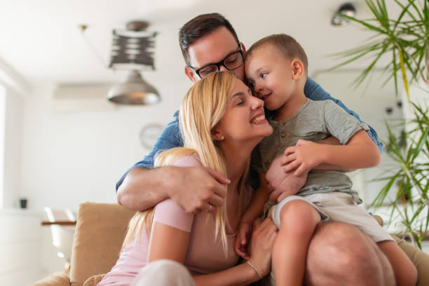 istock Young parents having fun with their son on bed at home 1086974388