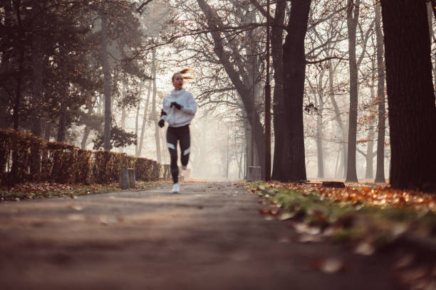 istock Woman jogging in the autumn park 1086975698