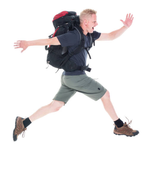 istock Attractive young male hiker running and jumping 1086979824