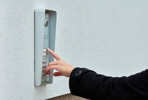 istock The female hand presses a button doorbell with camera and intercom 1086984788