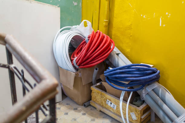 istock Temporary  stored construction materials, corrugated pipe , drywall, plumbing pipes and tubes in boxes  on the  back stair of apartment that is construction, remodeling, renovation, extension, overhaul and reconstruction 1086985488