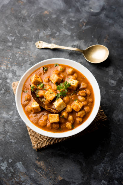 istock Chole Paneer curry made using boiled chickpea with cottage cheese with spices. Popular North Indian recipe. served in a bowl or serving pan. Selective focus 1086995818