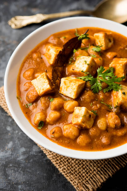 istock Chole Paneer curry made using boiled chickpea with cottage cheese with spices. Popular North Indian recipe. served in a bowl or serving pan. Selective focus 1086995974
