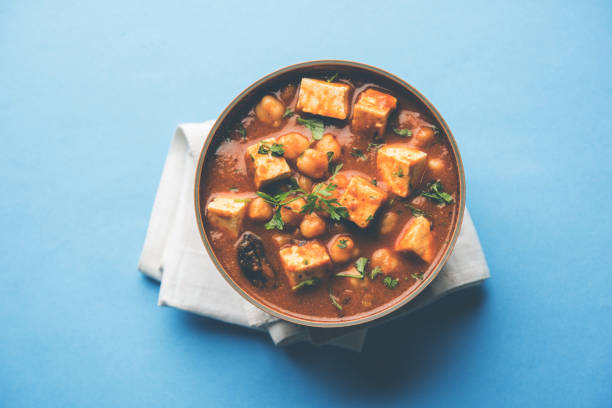 istock Chole Paneer curry made using boiled chickpea with cottage cheese with spices. Popular North Indian recipe. served in a bowl or serving pan. Selective focus 1086996166