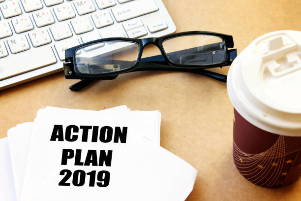 istock action plan 2019 on white paper with coffee and eyeglasses, white keyboard 1086997584