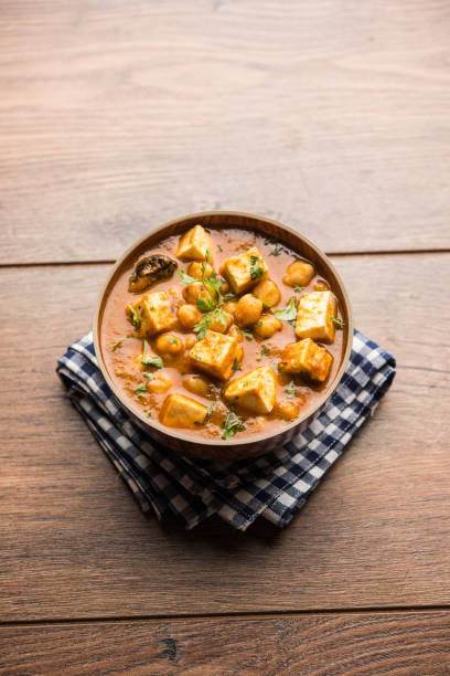 istock Chole Paneer curry made using boiled chickpea with cottage cheese with spices. Popular North Indian recipe. served in a bowl or serving pan. Selective focus 1086997592