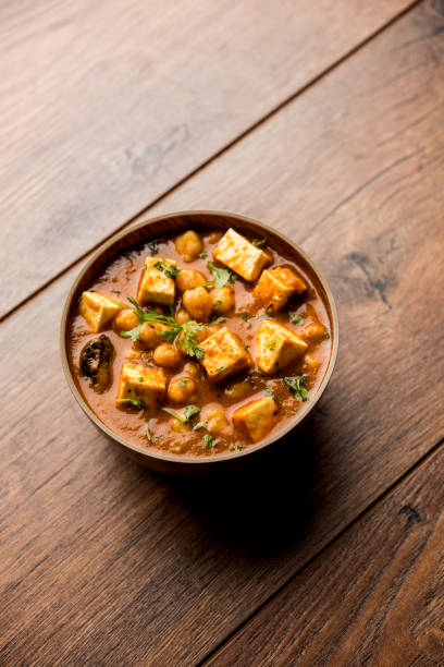 istock Chole Paneer curry made using boiled chickpea with cottage cheese with spices. Popular North Indian recipe. served in a bowl or serving pan. Selective focus 1086997674