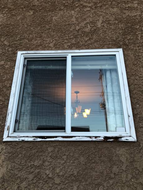 istock An old window with rotting wood trim. 1086997736