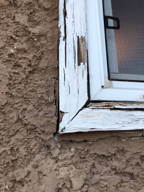 istock An old window with rotting wood trim. 1086997740