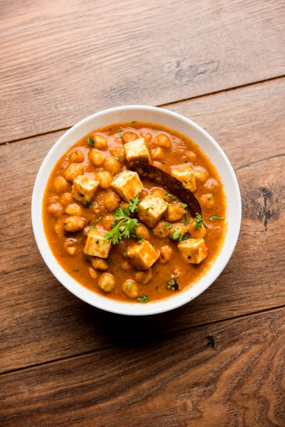 istock Chole Paneer curry made using boiled chickpea with cottage cheese with spices. Popular North Indian recipe. served in a bowl or serving pan. Selective focus 1086997790