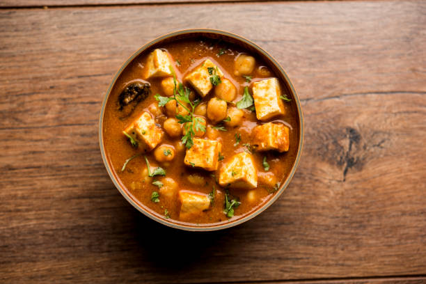 istock Chole Paneer curry made using boiled chickpea with cottage cheese with spices. Popular North Indian recipe. served in a bowl or serving pan. Selective focus 1086999512