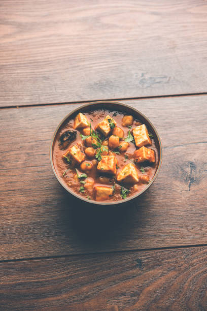 istock Chole Paneer curry made using boiled chickpea with cottage cheese with spices. Popular North Indian recipe. served in a bowl or serving pan. Selective focus 1086999622