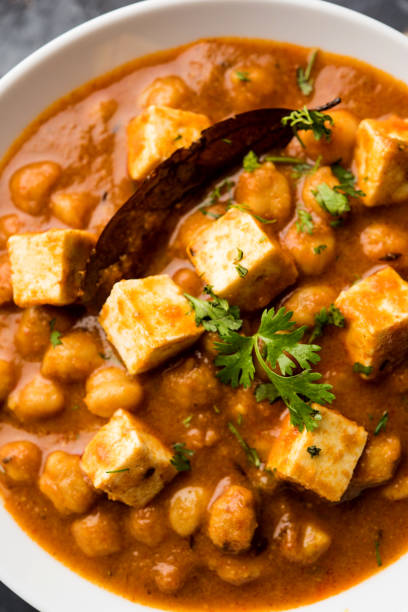 istock Chole Paneer curry made using boiled chickpea with cottage cheese with spices. Popular North Indian recipe. served in a bowl or serving pan. Selective focus 1087001276