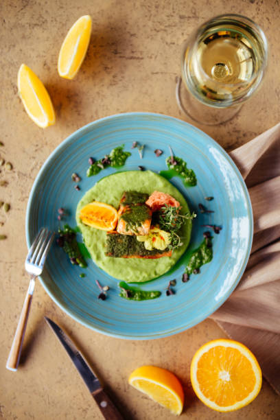 istock Baked salmon garnished with asparagus and tomatoes with herbs. 1087001302