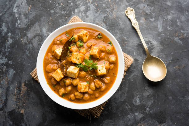 istock Chole Paneer curry made using boiled chickpea with cottage cheese with spices. Popular North Indian recipe. served in a bowl or serving pan. Selective focus 1087001388