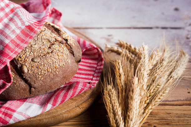 istock Bread on a kitchen towel lying on a wooden table 1087001430