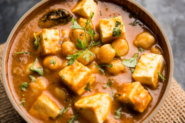 istock Chole Paneer curry made using boiled chickpea with cottage cheese with spices. Popular North Indian recipe. served in a bowl or serving pan. Selective focus 1087001520