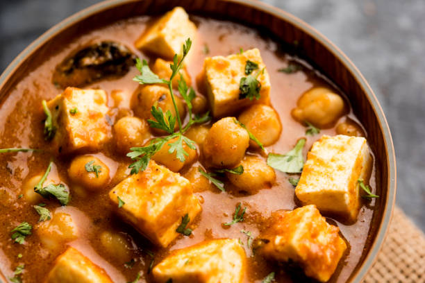 istock Chole Paneer curry made using boiled chickpea with cottage cheese with spices. Popular North Indian recipe. served in a bowl or serving pan. Selective focus 1087001560