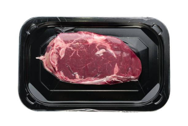 istock Vacuum black plastic pack with fresh beef steak isolated 1087006730