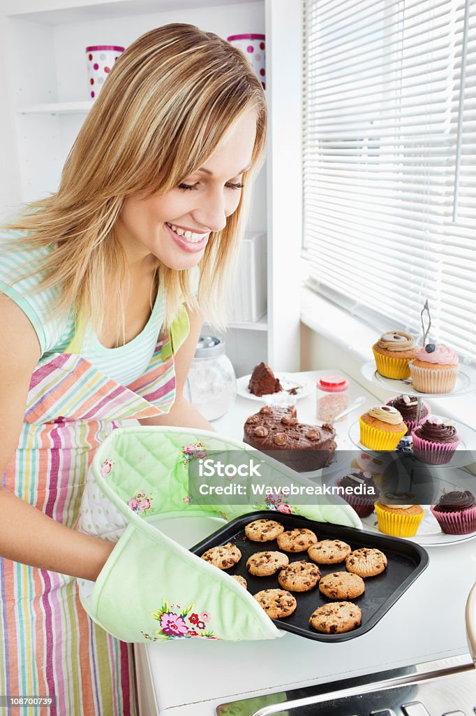 Charming woman baking in the kitchen Charming woman baking in the kitchen at home Adult Stock Photo