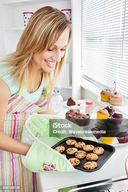 Charming Woman Baking In The Kitchen Stock Photo - Download Image Now - Adult, Bakery, Baking