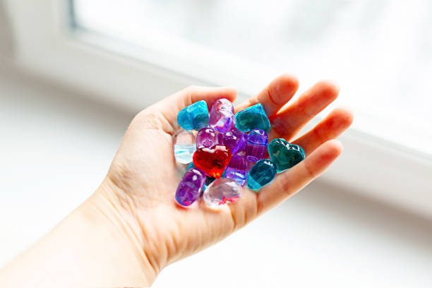 istock Colorful plastic hearts in a hand on daylight 1087011674