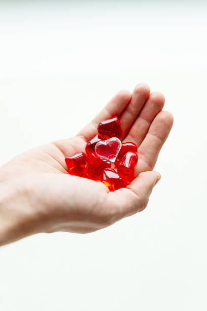 istock Colorful plastic hearts in a hand on daylight 1087011714