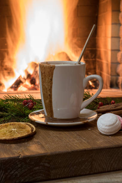 istock Cozy scene before fireplace mug with hot chocolate, mulled fruit and marshmallow. 1087014818