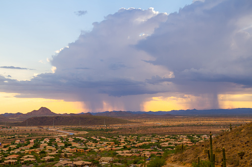 A monsoon storm over the desert of Arizona during sunset.