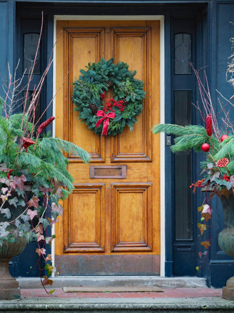 istock front door with Christmas wreath made of pine branches 1087018856