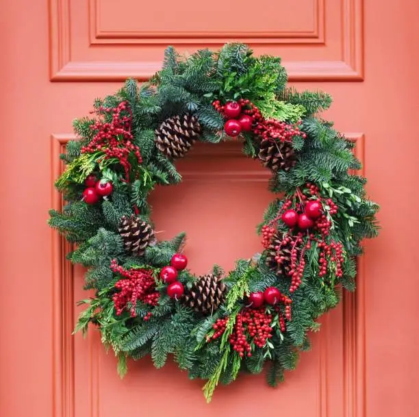 Photo of front door with Christmas wreath made of pine branches