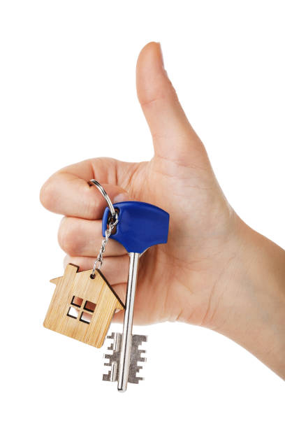 istock House keys in hand isolated on white background. Thumb gesture showing that everything is fine 1087019694