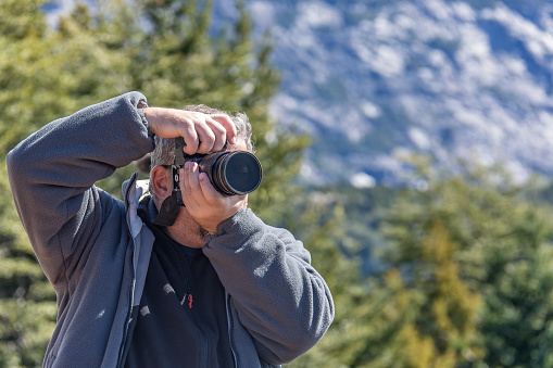 Photographer registering outdoor landscapes in cold season in Bariloche, Patagonia Argentina