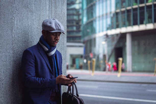 istock Businessman sending text message in the city 1087025818