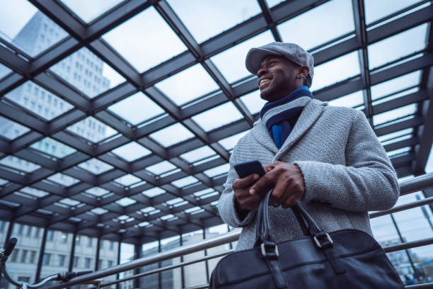 istock Businessman sending text message in the city 1087026114