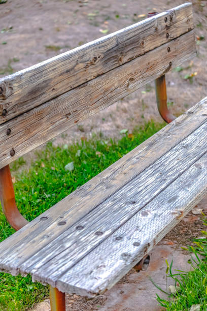 istock Weathered wooden bench with rusting metal support 1087034102