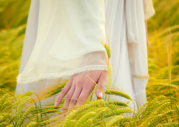 istock Woman walking through the wheat field 1087038140