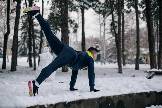 istock Young man exercising on winter day 1087040160