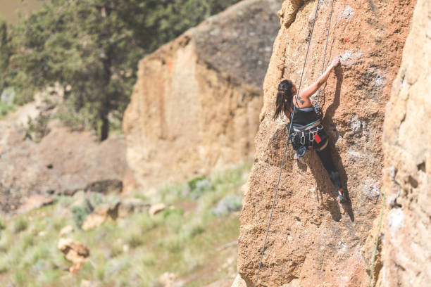 istock Young woman climbing a rock face in Oregon 1087045404