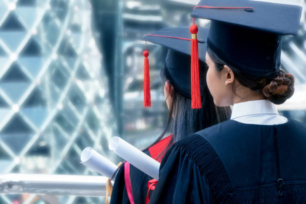 istock two Asian female grduated students at the back view 1087048172