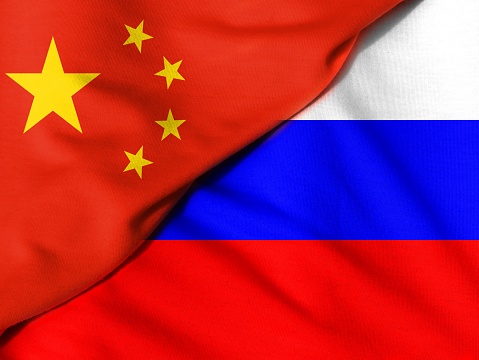 Crumpled flags. Flag of the People's Republic of China. Russian flag.