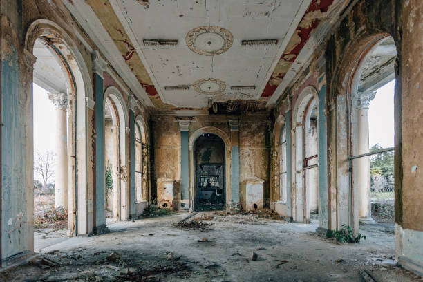 istock Ruined large hall interior overgrown by plants and moss 1087052988