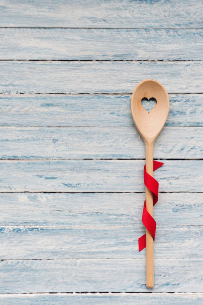Stirring spoon on a wooden background. Valentines day and winter holidays cooking and celebration concept. Top view, flat lay, copy space.