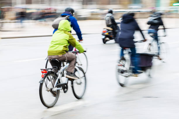 istock people riding bicycle on a rainy day 1087069842