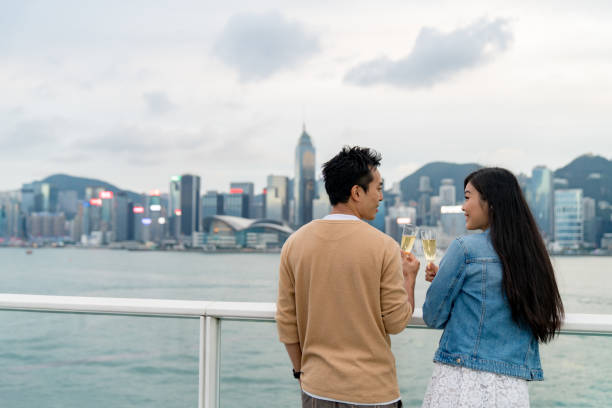 istock Young couple drinking champagne outdoors together 1087076432