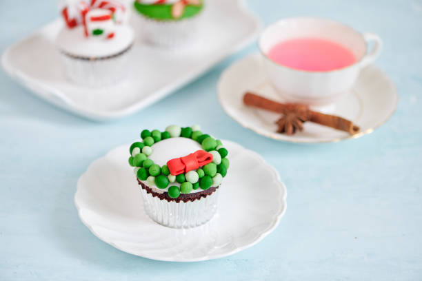 istock Homemade Christmas cupcake with traditional red green decorative symbols elements 1087081248