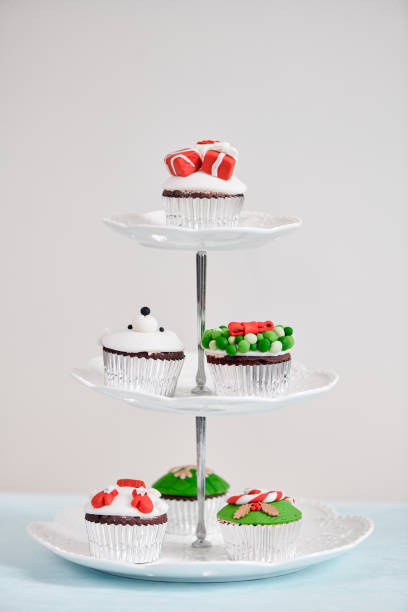 istock Homemade Christmas cupcake with traditional red green decorative symbols elements 1087081356