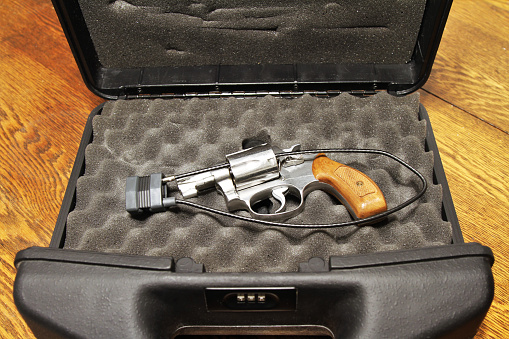 Revolver in lock case with combination lock for secure storage. Gun is also secured with a cable padlock through the open bullet cylinder.